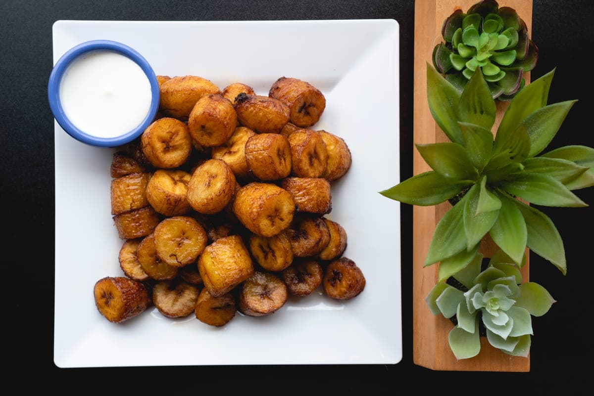 Sweet plantains (maduros) drizzled with crema