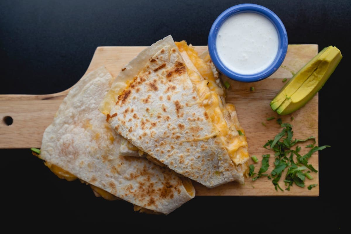 Cheese quesadilla with sour cream and avocado